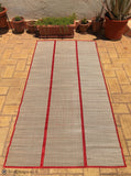 Handwoven Natural Reed Fold up Mat with Red Trim